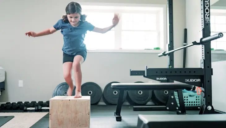 Kid jumping on box