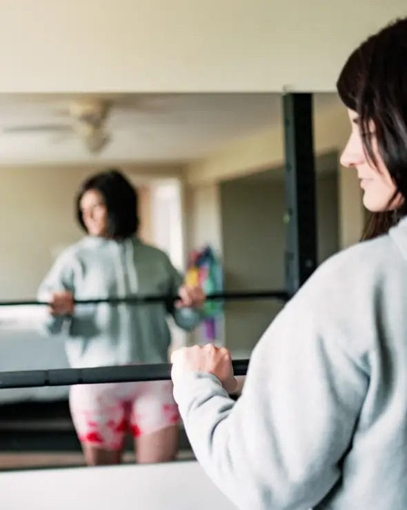Teen setting up barbell
